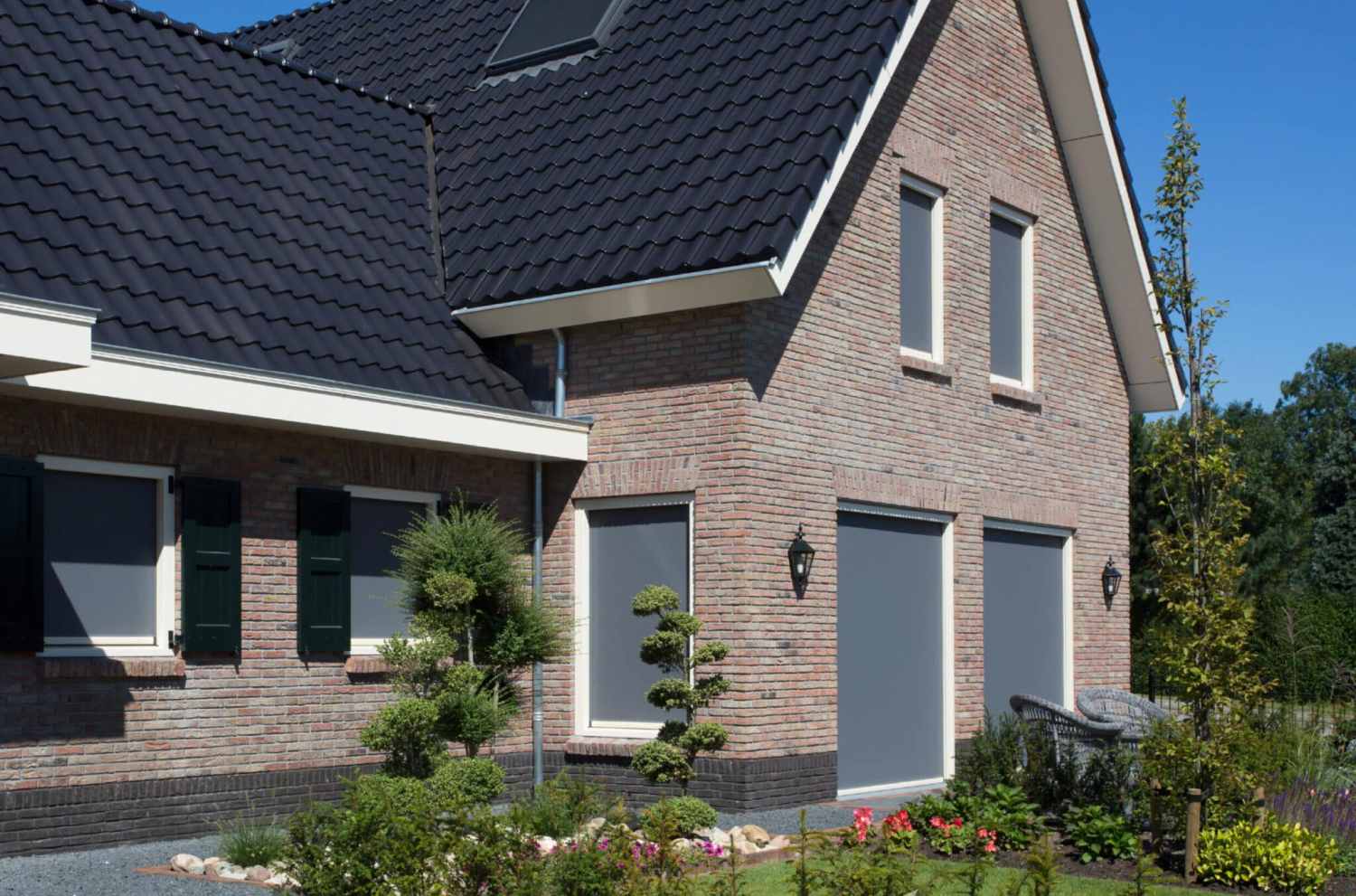 Zwarte ritsscreen zonwering aan woning in Friesland