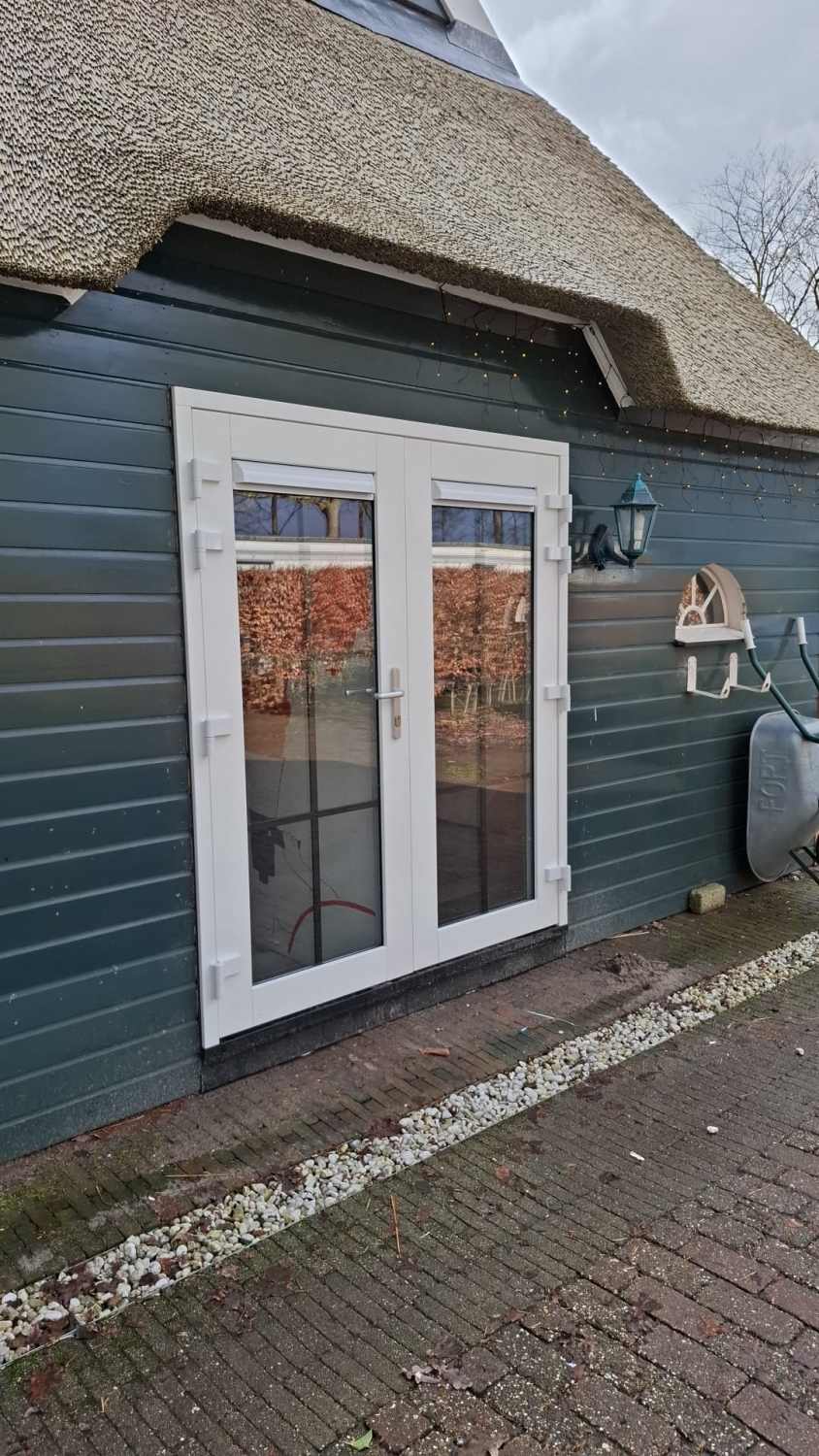 Witte kunststof tuindeuren bij landelijke woning in Waskemeer